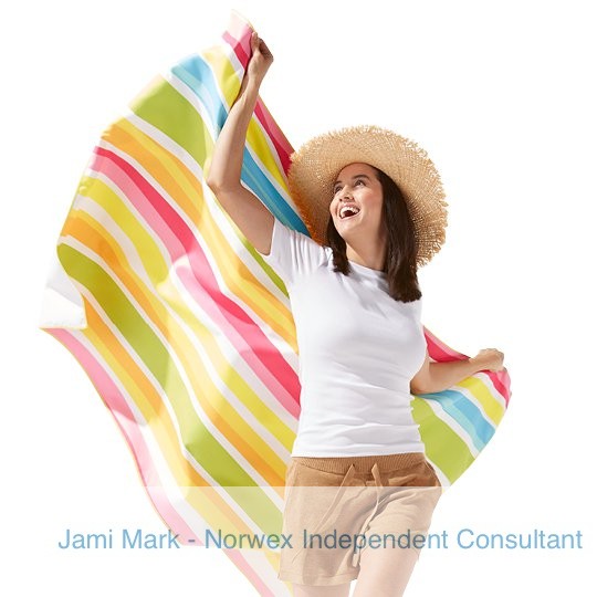 Woman with the Norwex beach towel and pouch