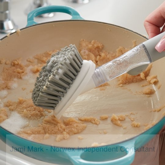Scraping stuck on food with the Norwex kitchen brush