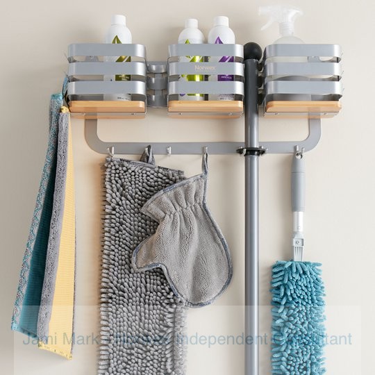 Norwex mop storage system holding many Norwex cleaning items